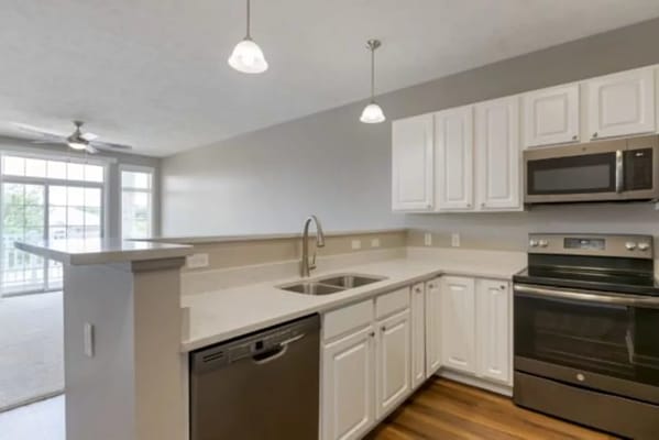 Spacious kitchen featuring modern appliances and light cabinetry