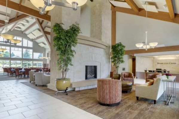 Spacious lobby with seating and a fireplace