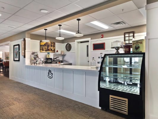 Interior dining area with serving counter and fridge
