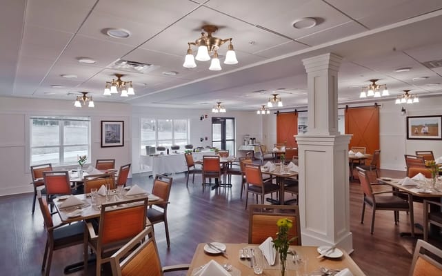 Bright dining room with tables set for meals