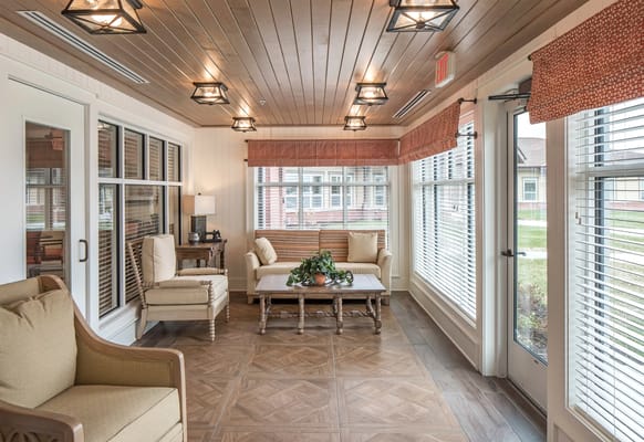 Bright common area with seating and large windows