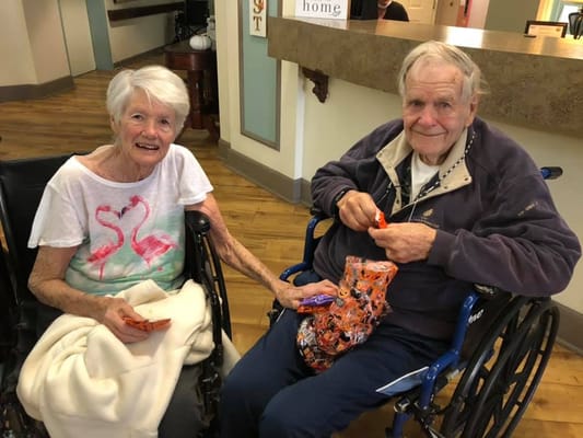 Two residents enjoying treats in a common area