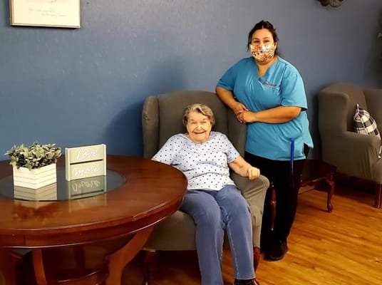 Resident and staff member in a common area