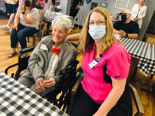 A senior resident with a staff member in a common area