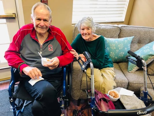 Two residents enjoying dessert in a common area