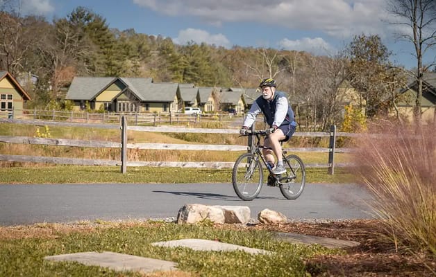 A resident cycling on a path near the facility