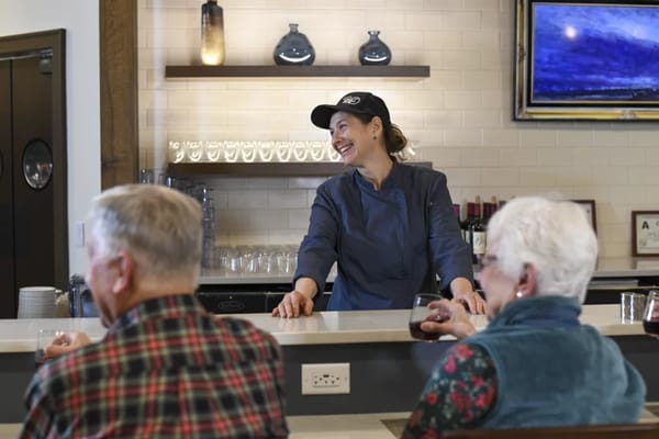 Staff member interacting with residents at a service counter