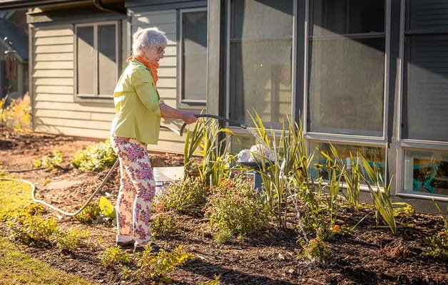 Resident gardening near the facility