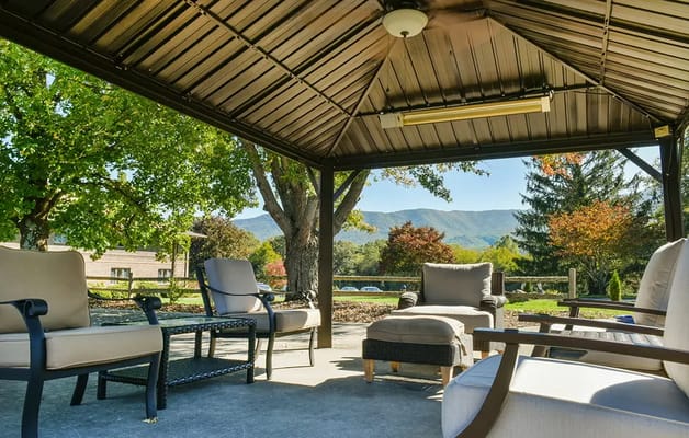 Covered outdoor seating area with mountain views