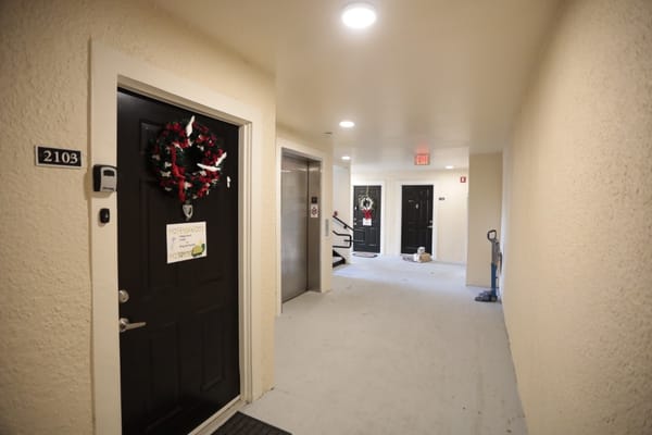 Hallway with decorated doors and accessible features