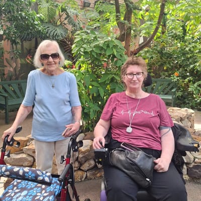 Two residents enjoying a garden area