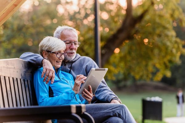 Couple enjoying time together on a bench in a garden