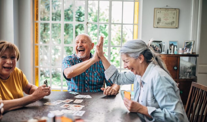 Seniors enjoying a card game in an activity room