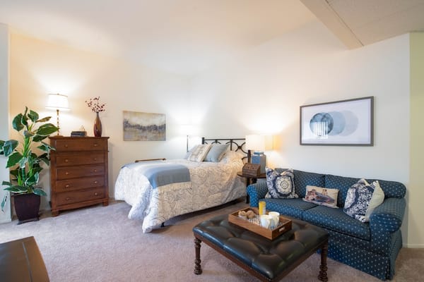 Cozy private room with a bed and seating area