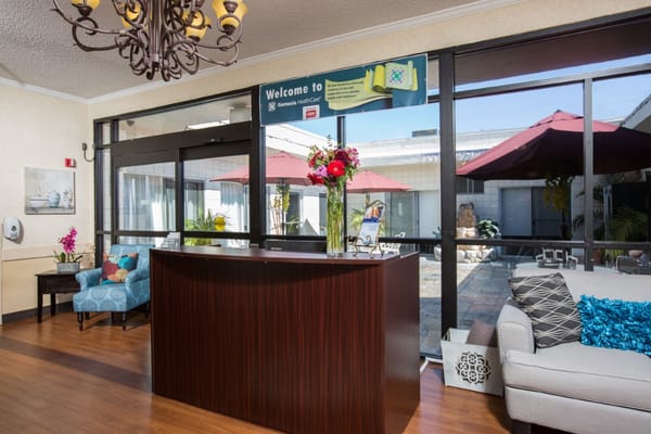 Reception desk with flowers and seating area