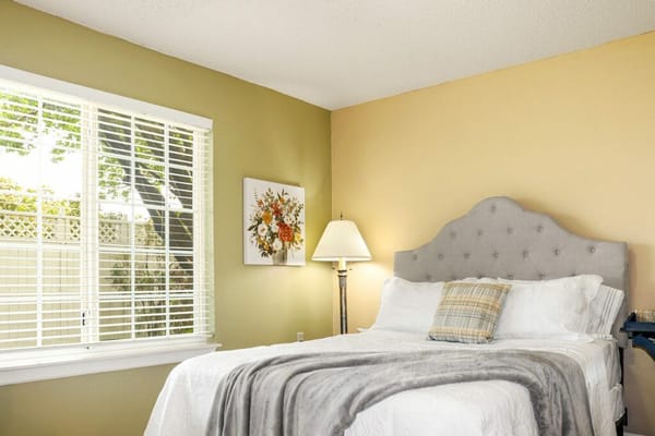 Cozy resident room with a bed and lamp