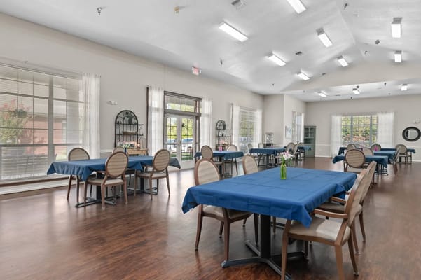 Bright dining room with tables set up for residents