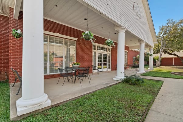 Exterior patio area with seating and hanging plants