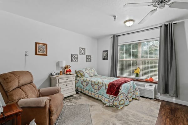 Cozy private resident room with a bed and chair