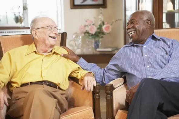 Two residents enjoying a joyful conversation in a common area