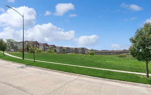Exterior view of AVIVA Woodlands facility with landscaped grounds