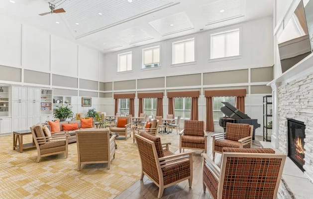 Bright common area with seating and a piano