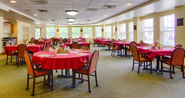 Comfortable dining area with round tables and red tablecloths