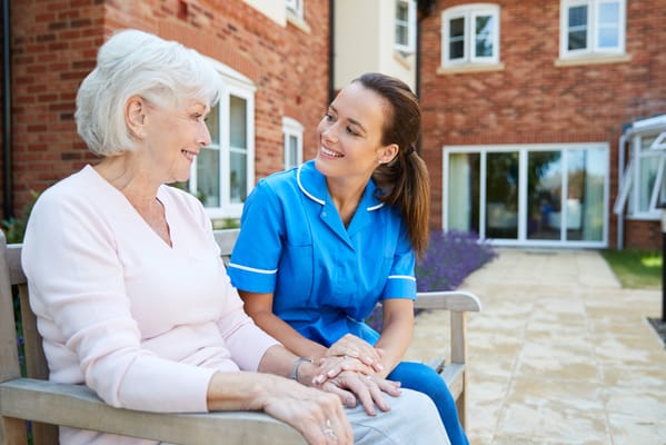 Caregiver interacting with a resident outdoors