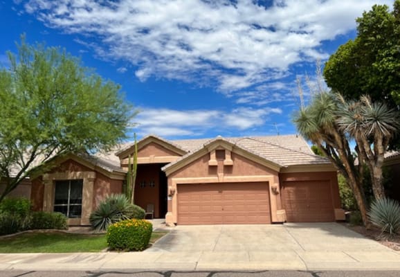 Exterior view of an assisted living facility with gardens