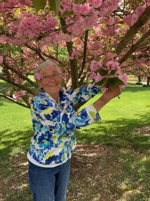 Resident enjoying spring blossoms in the garden