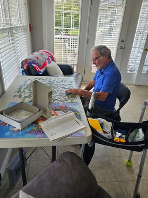 Resident working on a puzzle in a bright room