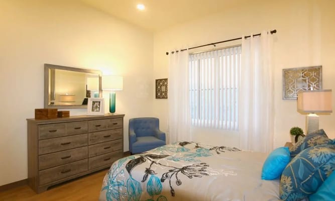 Brightly decorated resident bedroom with furnishings