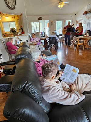 Residents enjoying a musical performance in a common area