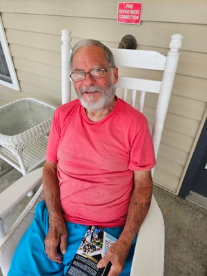Resident sitting outdoors on a porch