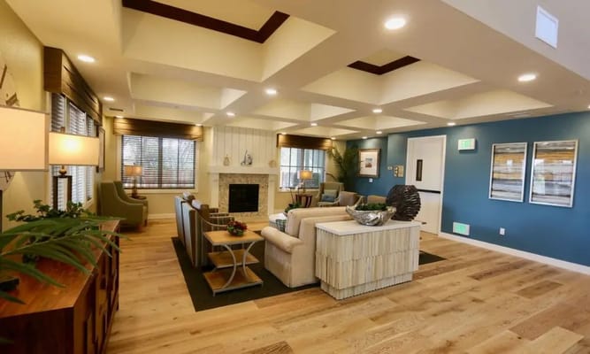 Bright common area with seating and a fireplace