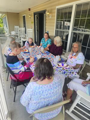 Residents enjoying a social event on a porch