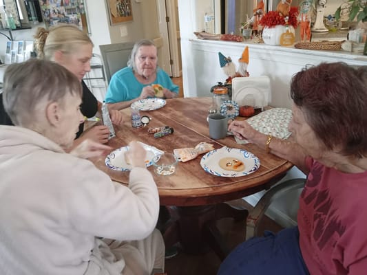 Residents and staff enjoying an activity around a table