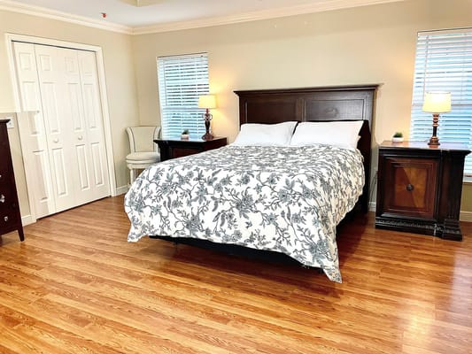 A well-furnished bedroom with a floral bedspread.