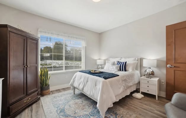 Brightly furnished resident bedroom with natural light