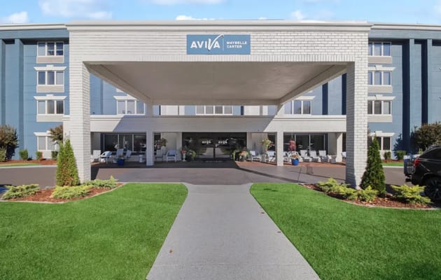 Front entrance of a senior living facility with landscaping