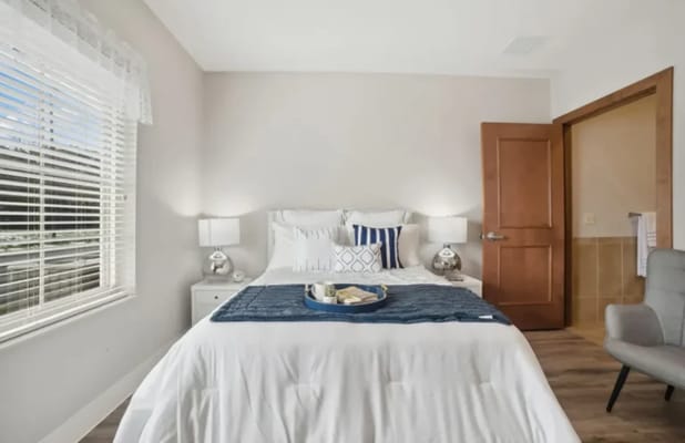A well-decorated private resident room with a bed