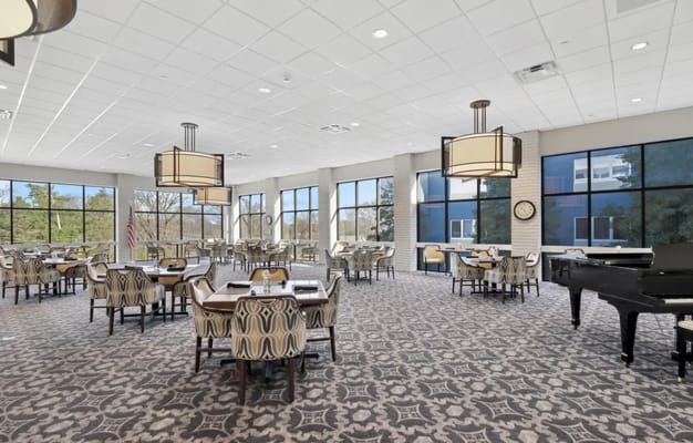Bright dining room with modern furnishings and large windows