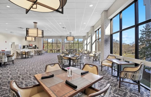 Spacious dining area with large windows and modern decor