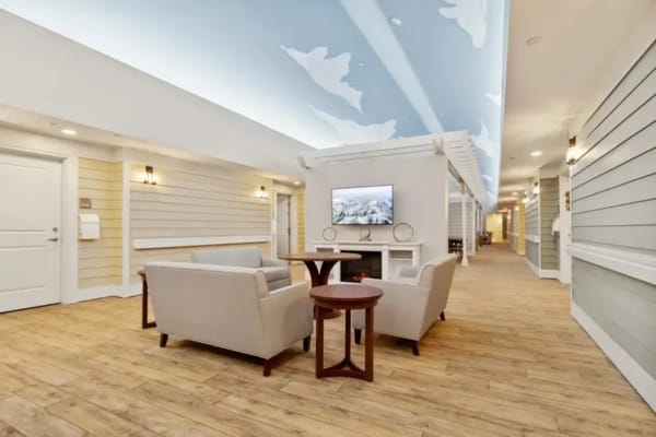 Bright common area with seating and TV