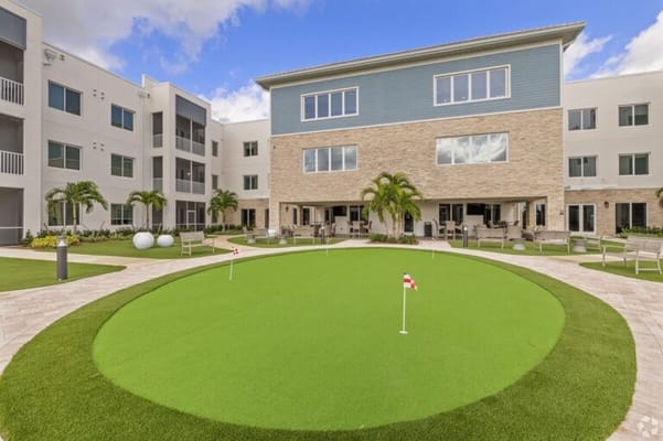 Outdoor area with putting green and building facade