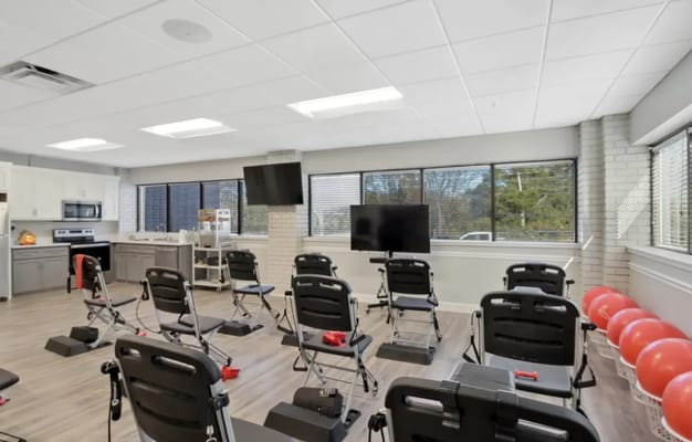 A well-lit activity room with exercise equipment