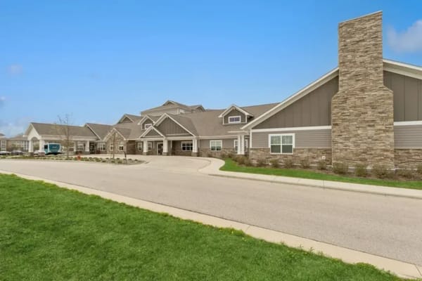 Exterior view of a senior living facility with gardens
