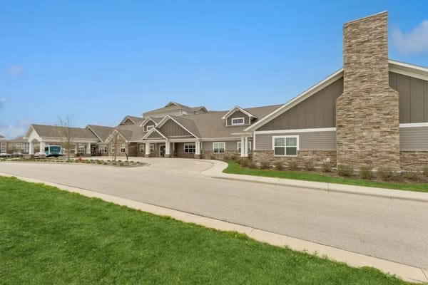 Exterior view of a senior living facility with gardens