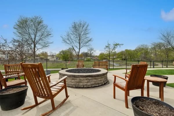 Outdoor seating area with a fire pit and trees