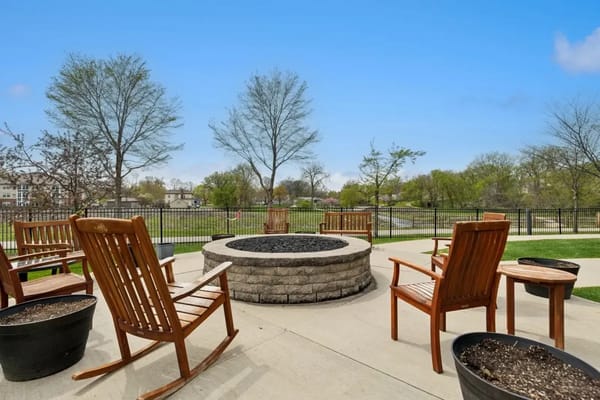 Outdoor seating area with a fire pit and trees